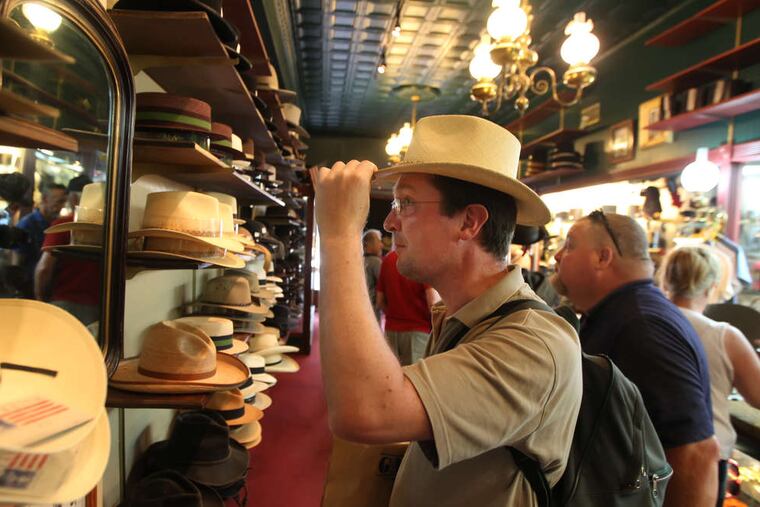 Didier Letoile, a Napoleonic reenactor from Paris, tries a chapeau in Dirty Billy's Hats, Gettysburg. Owner Fran Wickham said business was great.