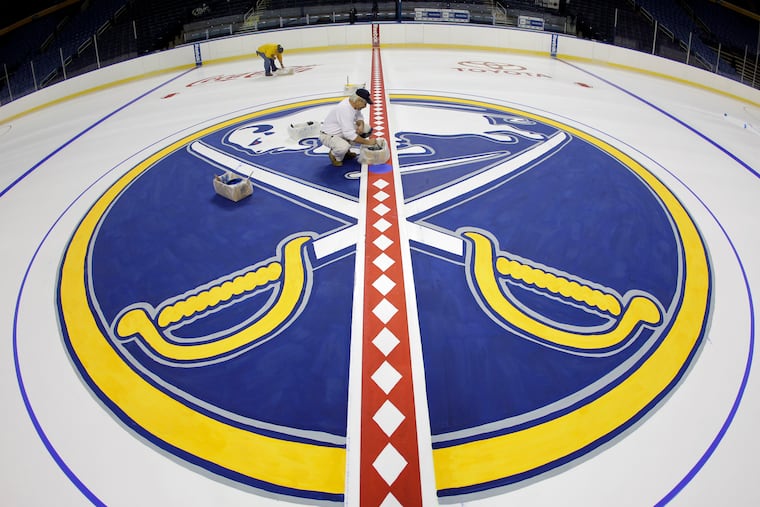 The Buffalo Sabres logo on the ice is shown.