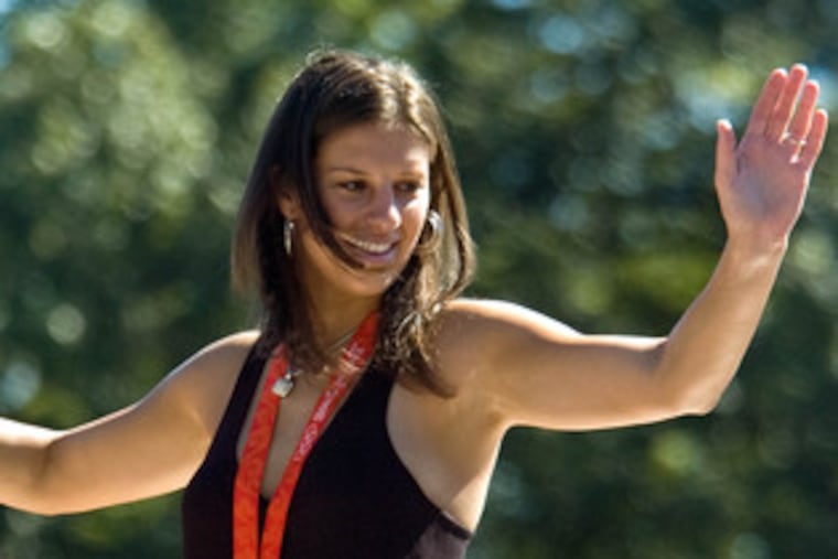 Carli Lloyd shows off her gold medal at a welcome-home parade in Delran on Sept. 1.