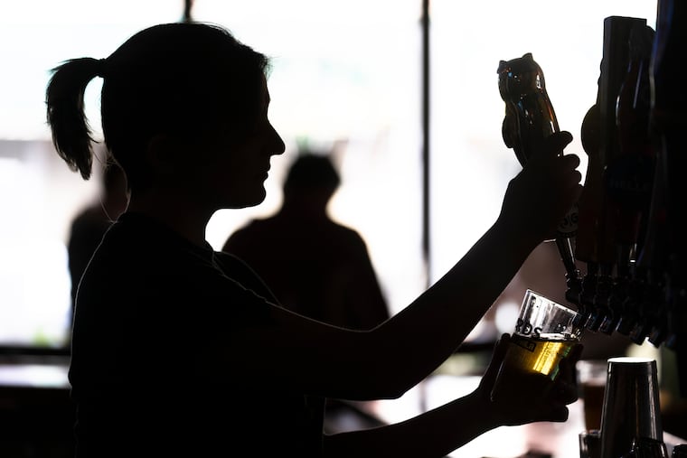 A bartender poured a beer at McMenamin's Tavern in Philadelphia on Feb. 9.