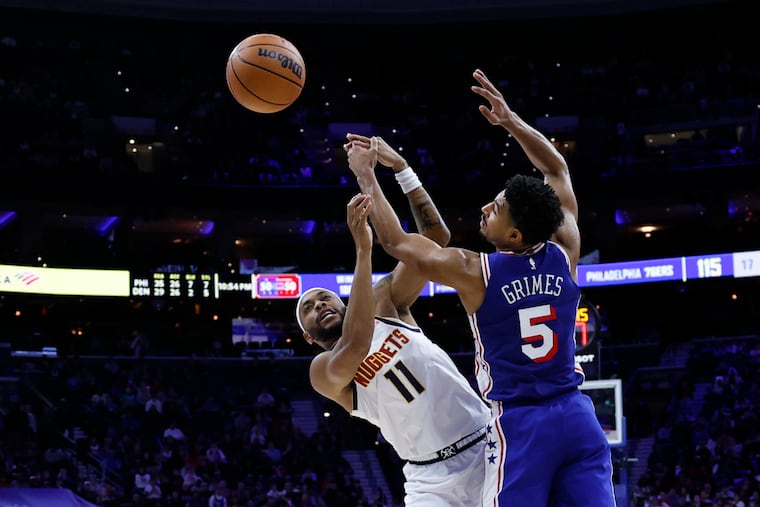 Sixers guard Quentin Grimes loses the basketball while being defended by Nuggets guard Bruce Brown in overtime on Monday.