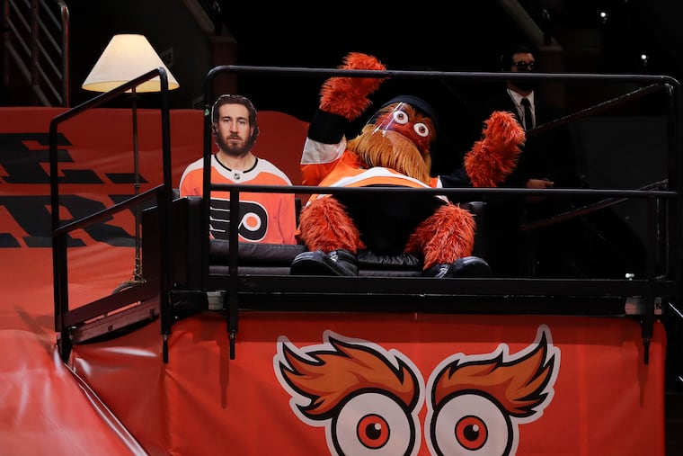 Flyers mascot Gritty sits next to a cutout of Flyers center Kevin Hayes during a break. Gritty is offering personalized video messages for $500 a pop to benefit the Ed Snider Youth Hockey Foundation.