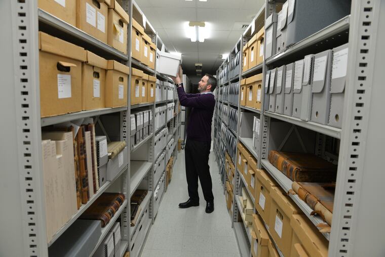 Cliff C. Parker, archivist with the county, uses old documents on a quest to identify a pre-Revolutionary War property.