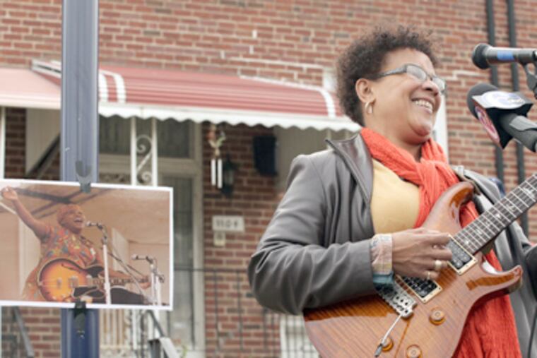 Jazz musician Monnette Sudler plays at the unveiling of the historical marker at the North Philadelphia home of Sister Rosetta Tharpe, shown in the small photo. (Caitlin Morris / Staff Photographer)
