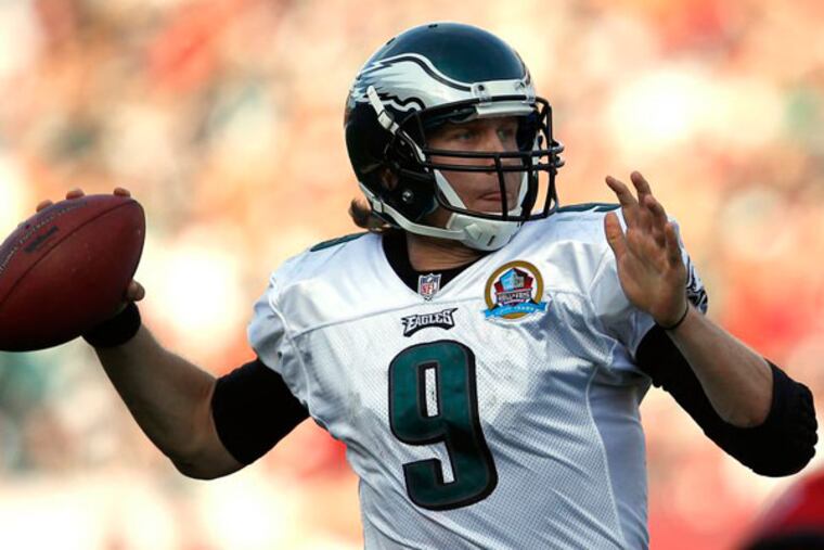 Nick Foles scrambles as he throws a pass to Clay Harbor for a touchdown late in the fourth quarter. (David Maialetti/Staff Photographer)
