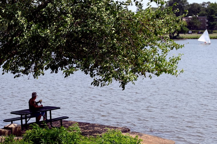 Nelson Rodriguez, 62, from Brooklyn, N.Y. finds a cool place to chill along the Cooper River in Pennsauken, N.J.