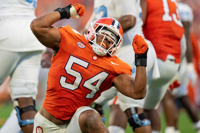 Clemson linebacker Jeremiah Trotter Jr. (54) reacts during a game against North Carolina on Nov. 18, 2023, in Clemson, S.C. Jeremiah Trotter Jr. wears his dad’s No. 54, plays the same position, and celebrates sacks and big tackles with the same signature axe swing.