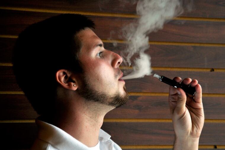 MadVapes store manager Robert Everhart uses an electronic cigarette at MadVapes in Charlotte, North Carolina. Electronic cigarettes are growing in popularity, but concern still lingers nationwide about their safety. e-Cig culture includes "vaping" meet-ups and an array of build-your-own products. (Diedra Laird/Charlotte Observer/MCT)