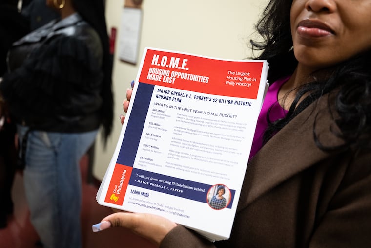A mayoral staffer holds an information sheet about Mayor Cherelle L. Parker’s affordable housing plan at the Church of Christian Compassion in West Philadelphia on Sunday.