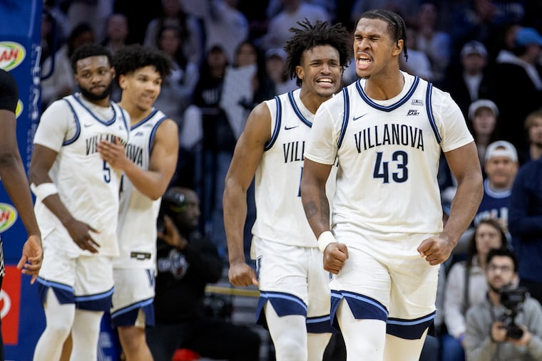 Eric Dixon (right) Jordan Longino, and their Villanova teammates celebrate a 75-73 victory over Providence.
