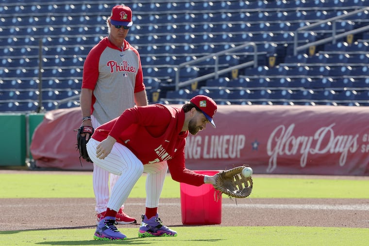 Phillies bench coach Don Mattingly oversees infield drills with first baseman Bryce Harper in Clearwater, Fla.