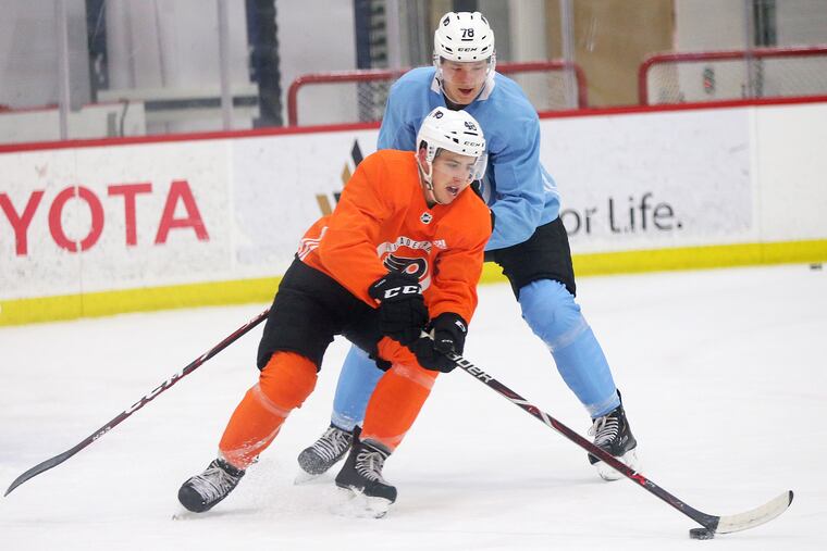 Morgan Frost, front, skates ahead of Matthew Strome during the first day of Flyers rookie camp Saturday in Voorhees.
