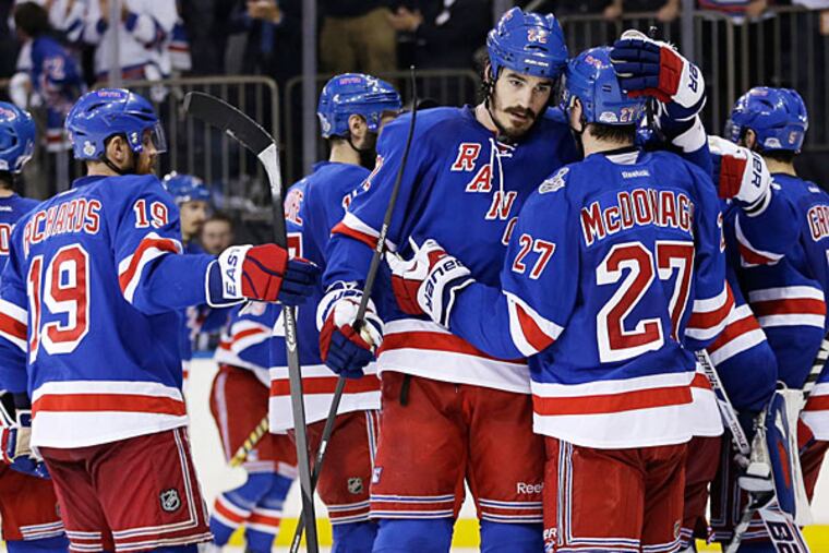 Rangers center Brian Boyle (22), center, greets defenseman Ryan McDonagh (27) after the Rangers beat the Los Angeles Kings 2-1 in Game 4 of the NHL hockey Stanley Cup Final, Wednesday, June 11, 2014, in New York. (Seth Wenig/AP)