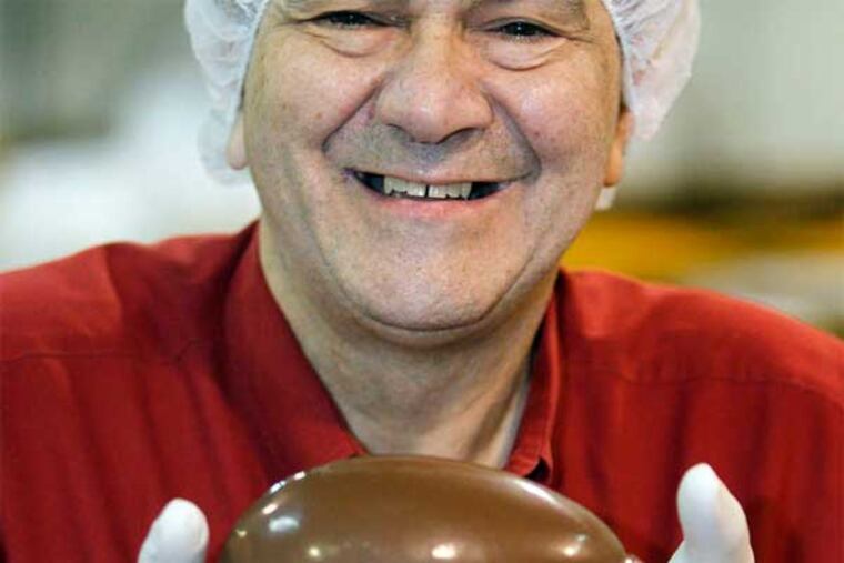 Co-owner Andy Kasparian holds a chocolate Easter egg - a dependable big seasonal draw - at Gabe's Candy & Nut House. (Akira Suwa / Staff Photographer)