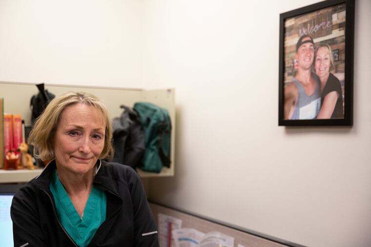 Dr. Bonnie Milas poses for a portrait in her office at the Hospital of the University of Pennsylvania on Thursday, April 18, 2019. Milas, an anesthesiologist at Penn, lost her son, pictured next to her, to an overdose and has since become an advocate for overdose prevention.