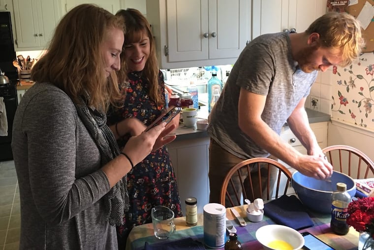 Sally Heimann’s daughter, Liz, left, with Rachel (son Andy’s girlfriend) and Andy. Andy is working on making pecan pie.