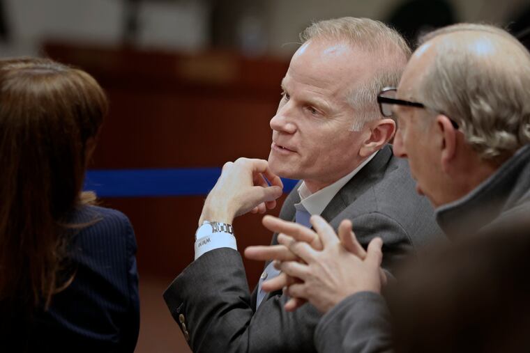 Bill McSwain (center) attends a school board meeting at the Central Bucks School District Educational Services Building in Doylestown on April 20, 2023.