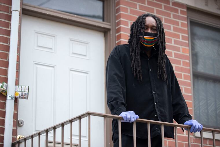 Jondhi Harrell posed for a portrait outside of his home in Philadelphia, Pa. on Thursday, April 16, 2020. Harrell was hospitalized for nine days with the coronavirus.