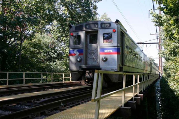 A SEPTA train crosses Swarthmore's Crum Creek bridge, among century-old structures SEPTA can finally replace, thanks to a $2.3B boost in statewide transportation funding. (Charles Fox / Staff Photographer)