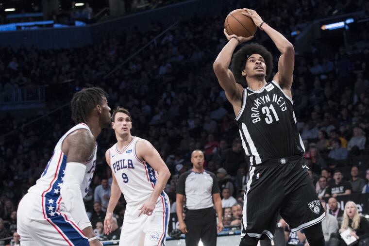 Brooklyn Nets center Jarrett Allen (31) shoots past Philadelphia 76ers forward Dario Saric (9) and forward Robert Covington during the second half.