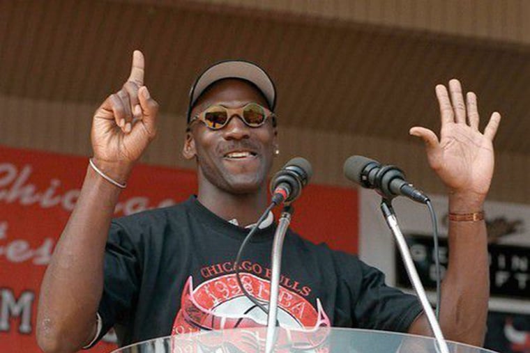 Michael Jordan holds up six fingers for each championship of the Chicago Bulls dynasty, on June 16, 1998.