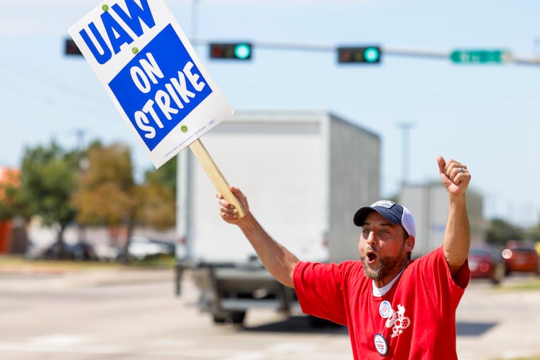 Co-chair of community service committee of UAW local 2360, Phillip Laws, reacts towards the ongoing traffic during a strike outside of Stellantis distribution center in Carrollton, Texas, on Friday.