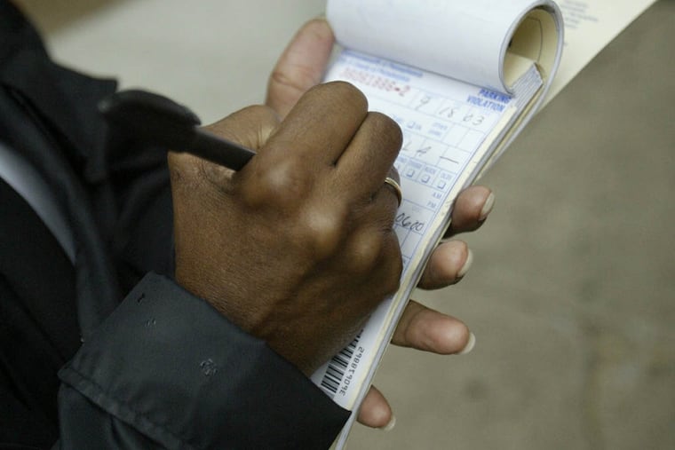 A Parking Authority employee writes tickets on Walnut Street in Philadelphia.