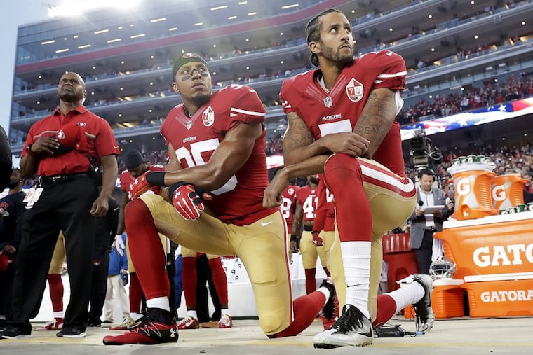 San Francisco 49ers safety Eric Reid (35) and quarterback Colin Kaepernick (7) kneel during the national anthem before an NFL football game against the Los Angeles Rams in 2016.