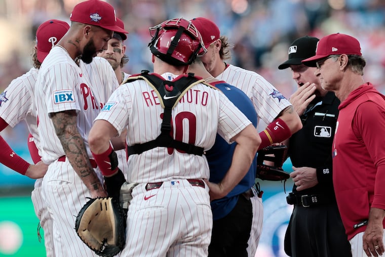 A Phillies trainer works on pitcher Cristopher Sánchez’s hand in the second inning after he had a scrape on his finger. He went on to throw seven scoreless innings.