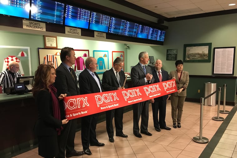 Tony Ricci, center, chief executive of Parx Casino, welcomes bettors at the official opening of the Parx Race and Sportsbook at the South Philadelphia Turf Club on Thursday. "You can finally make a legal sports bet in South Philadelphia," said Ricci, a native of South Philadelphia.