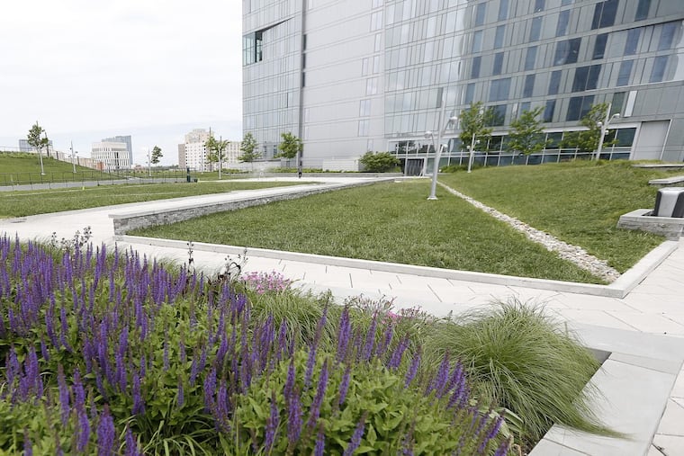 A section of the Evo student housing tower beside the Cira Green public plaza atop an adjacent parking garage.
