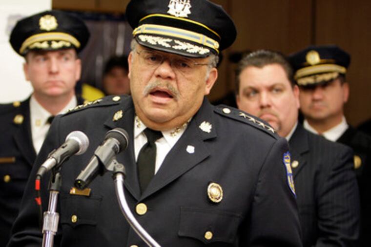 Commissioner Ramsey (with Mayor Nutter, at left in background) reviews the city's crime statistics - including the drop in homicides - yesterday at a news conference.