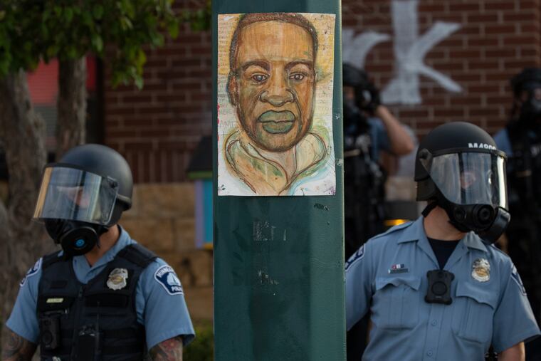 Minneapolis police stand outside the department's 3rd Precinct on May 27, 2020, in Minneapolis. President Joe Biden plans to sign an executive order on policing on Wednesday, the second anniversary of George Floyd's death.