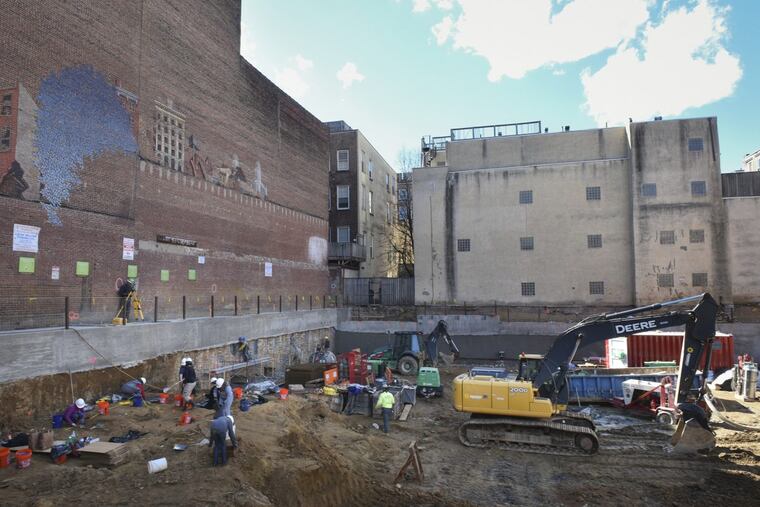 Volunteer archeologists work to exhume bodies buried at the former First Baptist burial ground in Old City in March.