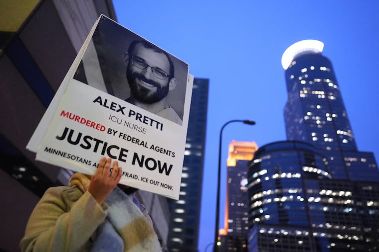 A person holds a sign of Alex Pretti during an anti-ICE protest in Minneapolis on Monday, Jan. 26.
