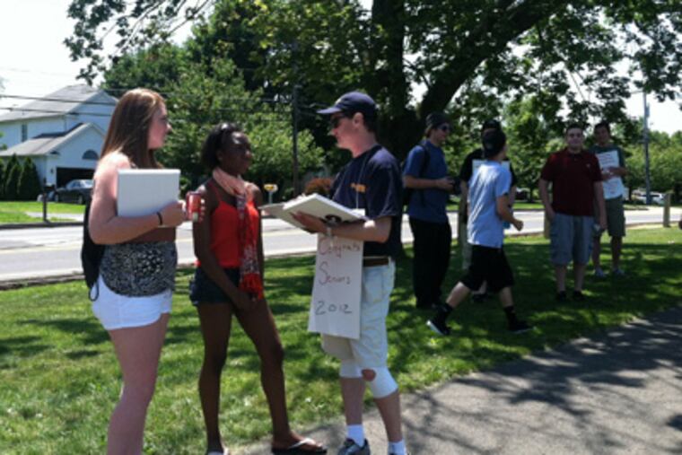 Maria Zeigler (center) gets her yearbook signed by sociology teacher Richard Greenberg during Neshaminy's Senior Picnic on Friday, in the midst of a teachers' strike. (Bill Reed / Staff)