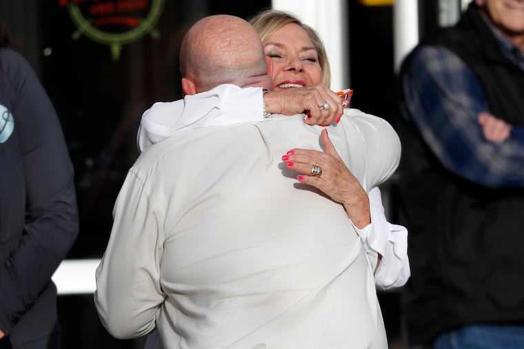 Beth Woydziak hugs a participant as he arrives to attend a faith-based memorial service for the victims of the massacre at Columbine High School nearly 20 years ago at a community church Thursday, April 18, 2019, in Littleton, Colo.
