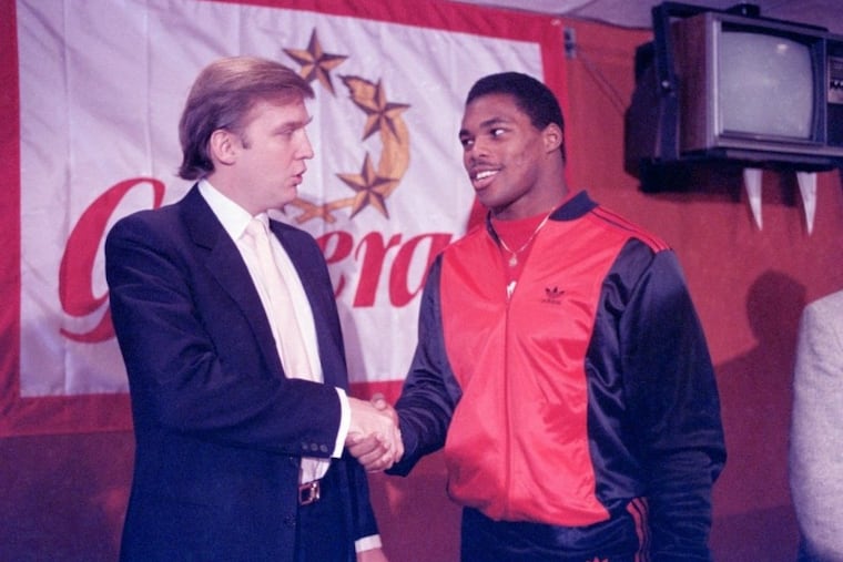 In this March 8, 1984, file photo, Donald Trump shakes hands with Herschel Walker in New York after an agreement on a four-year contract with the New Jersey Generals USFL football team.