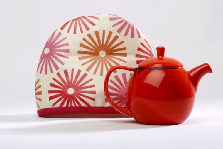 Hunker down with hot tea and keep your pot warm with this charming cozy, handmade by Cozy Toes in East Falls. Cozies come in two sizes and five designs. They are laminated on the outside, batted and lined with knit fabric inside. Curve 24-ounce teapot with infuser by ForLifeDesign.com in nine colors, dish washer and microwave safe.