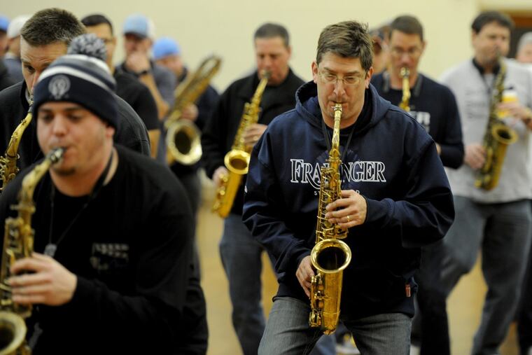 As 2018 arrives, John McDevitt (right), is looking forward to making a comeback with the Fralinger String Band. He and other band members rehearse at Holy Ghost Byzantine Catholic Church in South Philadelphia December 28, 2017. McDevitt joined the Mummers when he was in elementary school and for nearly three decades, he has been a regular in the New Year’s Day parade. But in 2017 he was sidelined by brain surgery.