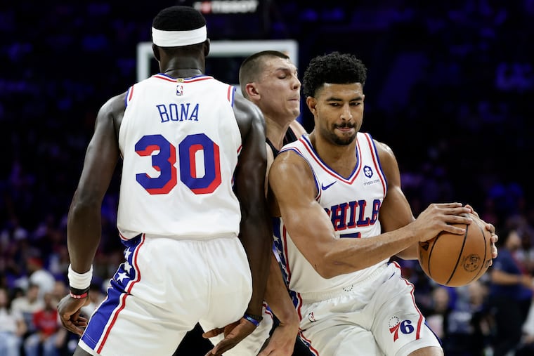 Sixers guard Quentin Grimes catches the ball as center Adem Bona sets a screen on Miami's Tyler Herro.
