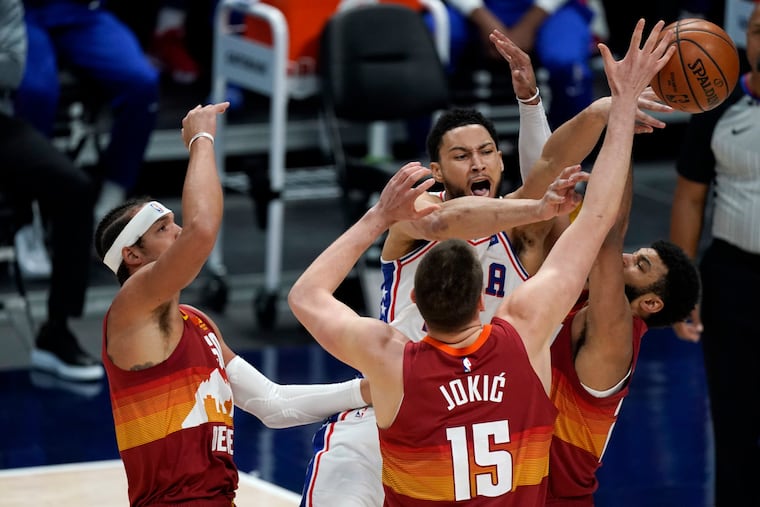 Sixers guard Ben Simmons, here surrounded by three Denver Nuggets, has struggled on the offensive end since the All-Star break without Joel Embiid (not pictured).