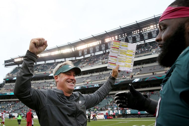 Eagles’ head coach Doug Pederson, left, celebrates the victory with Jason Peters, right. Philadelphia Eagles win 34-7 over the Arizona Cardinals in Philadelphia, PA on October 8, 2017. DAVID MAIALETTI / Staff Photographer