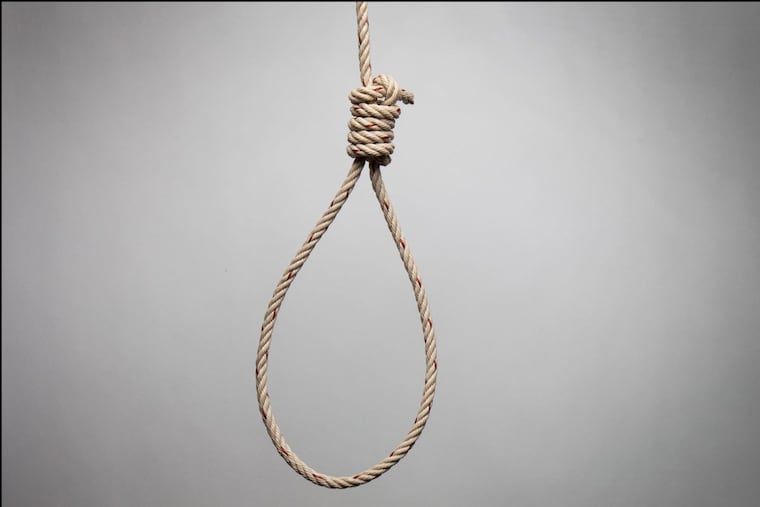 Hands holding rope slipknot in concept suicide