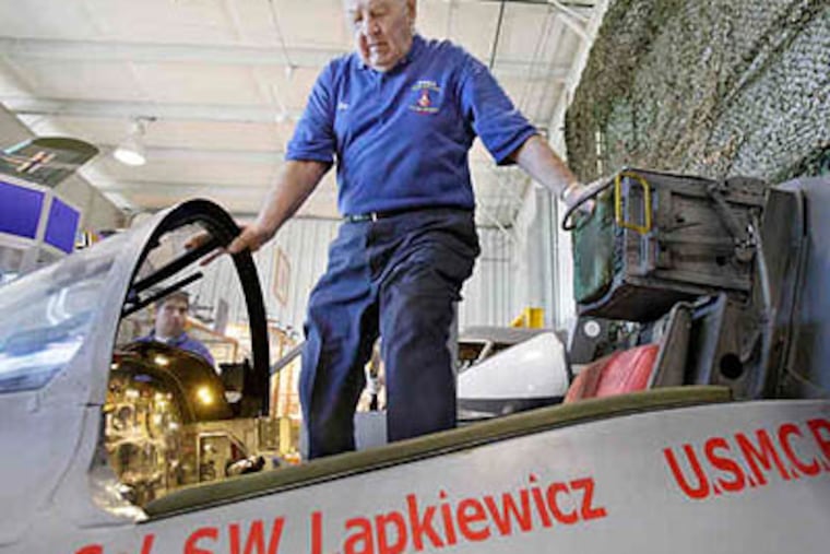 Marine Col. Sylvester Lapkiewicz, better known as "Col. Lap," 86, gets in a 1953 North American FJ-3 Fury flight simulator at at the Wings of Freedom Aviation Musuem in Willow Grove. (Elizabeth Robertson / Staff Photographer)