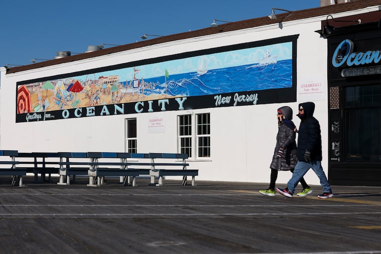 People walk down the boardwalk in Ocean City, N.J., on Jan. 17, 2024. Boardwalk buskers now face a $200 permit fee and will be restricted where they can perform.