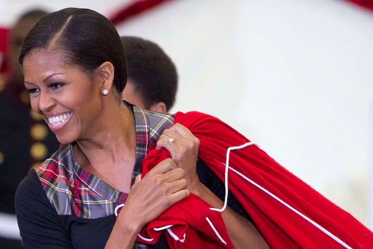 Michelle Obama carries a bag of toys donated by White House staffers for the annual Toys for Tots campaign.