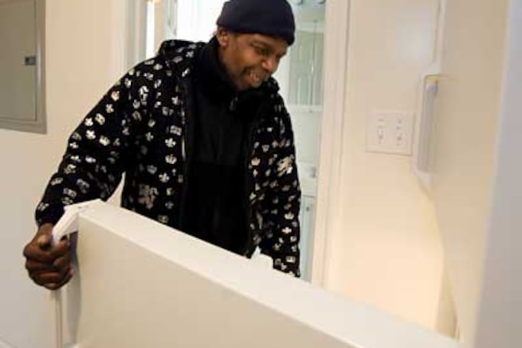 Robert Ford, a disabled truck driver living on the streets of Philadelphia, tours his new apartment obtained through the Pathways to Housing program. (Ed Hille / Staff Photographer)