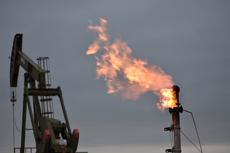 A flare for burning excess methane, or natural gas, from crude oil production is seen at a well pad in Watford City, N.D. Proposals in the GOP reconciliation bill will open up public lands to more development and extraction.