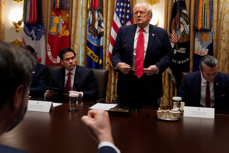 Vice President JD Vance (foreground) pumps his fist as President Donald Trump stands up following a cabinet meeting at the White House last week. Earlier, Trump had called Somalis in the U.S. "garbage" and claimed they "contribute nothing."